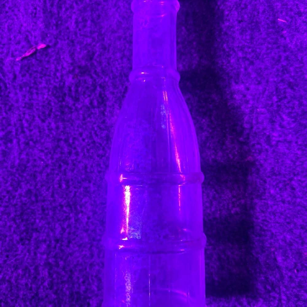 Vintage condiment bottle with unique shape.